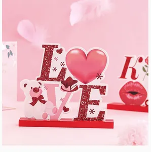 Détail d'une décoration de table en bois pour la Saint-Valentin avec le mot LOVE et un coeur