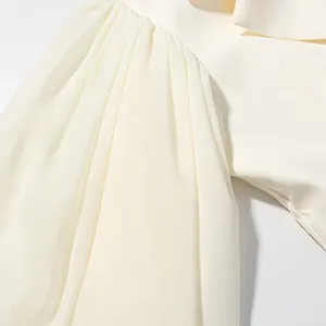 Detail shot of elegant off-white pleated flare sleeve on a lightweight summer blazer