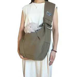 Detailed view of a brown solid color pet sling carrier bag worn by a model for pet travel
