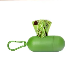 Detailed macro view of the green capsule-shaped pet waste bag dispenser with hook