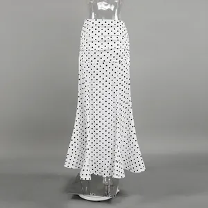 Detail view of a French style white and black polka dot maxi skirt with draped high waist.