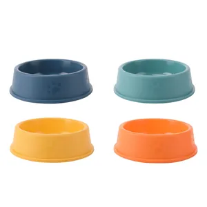Set of four durable plastic pet dog bowls in vibrant colors for feeding and water