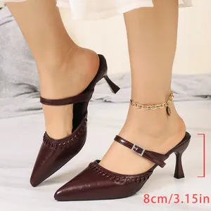 Detail of French retro burgundy pointed-toe mules with kitten heel and buckle strap