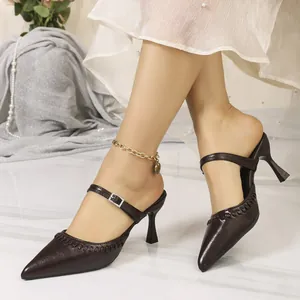 Close-up of elegant dark brown pointed-toe high heel mules with a stylish buckle strap