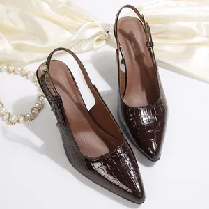 Detailed view of dark brown crocodile embossed leather pointed toe slingback high heel pumps.