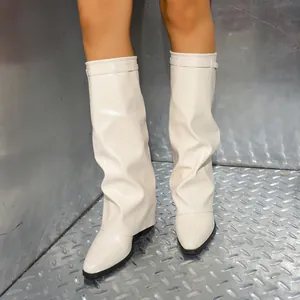 Frontal shot of the cream pleated material on the shark lock style knee-high fashion boots