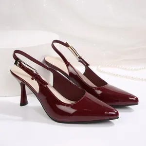 Detailed side view of elegant burgundy pointed-toe slingback high heels with gold buckle