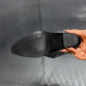 Detailed macro view showing the anti-slip sole and chunky heel of these stylish black boots