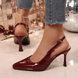 Detailed view of wine red patent leather pointed-toe slingback heels with buckle