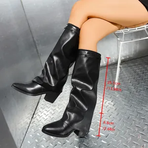 Close-up of black slouchy knee-high boots showing shaft and heel height measurements
