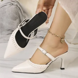 Detail of French vintage pointed-toe mule with rhinestone buckle and kitten heel