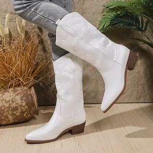 Elegante witte cowboylaarzen met prachtig borduurwerk en een comfortabele blokhak.