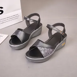 Detail van grijze sleehaksandalen met glitterteen en verstelbare enkelbandsluiting