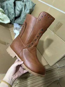Detail view of stylish brown women's knight boots featuring rivet accents and a back zipper.