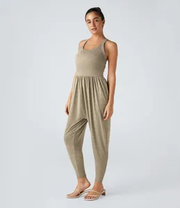 Detailed view of women's sleeveless khaki jumpsuit with cinched waist and jogger cuffs
