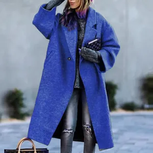 Women's royal blue long wool coat with oversized lapel in a street style setting