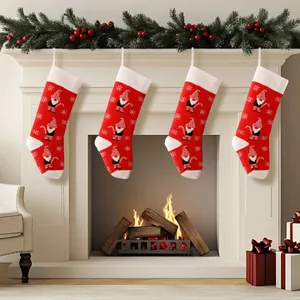 Red and white knitted Christmas stockings with gnome pattern on fireplace mantel