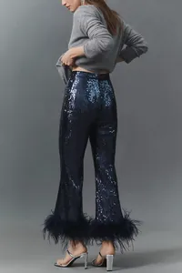Detailed back view of navy blue sequin flared trousers with chic feather trim at hem