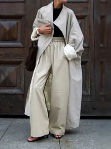 Oversized light apricot trench coat with large lapels and satin lining for autumn.