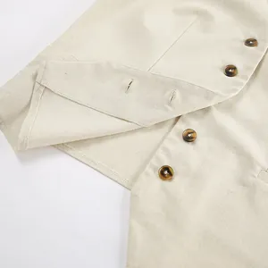 Close-up detail of tortoise shell buttons and stitching on khaki cotton linen vest