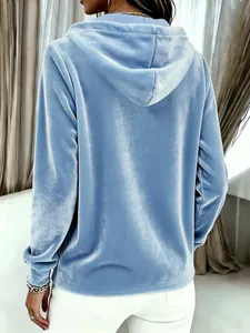 Back view detail of a light blue velvet hooded sweatshirt showing the soft fabric texture