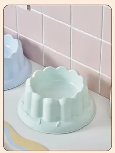 Detailed macro view of a pastel green fluted pet bowl with anti-tip design base