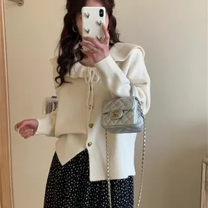Detail view of a white Korean style doll collar knit cardigan with heart buttons