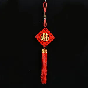 Close-up of red felt Chinese New Year hanging ornament with gold Fu character and tassel