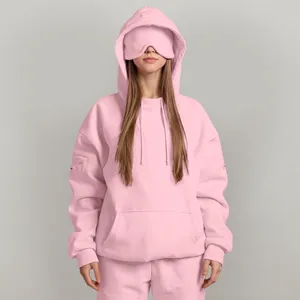 Detail view of pink oversized hoodie with a unique built-in eye mask for comfort