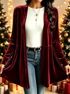 Close-up detail of an elegant burgundy gold velvet cardigan for women in a festive setting