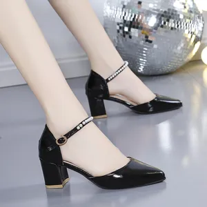 Side view of black patent leather chunky heel sandals with elegant pearl strap detailing