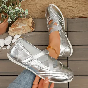 Close-up of metallic silver Mary Jane ballet flats featuring elastic cross straps