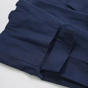 Close-up detail of navy blue cotton linen fabric showing pocket stitching and texture
