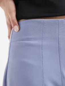 Close-up of elegant high-waisted trousers showing fine fabric texture and tailored seams
