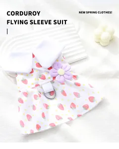 Close-up detail of white strawberry print pet dress with a cute purple flower ornament.