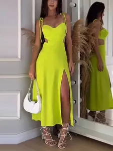 Elegant neon yellow summer maxi dress featuring side cutouts and a high leg slit