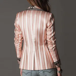 Close-up showing the elegant pink striped satin texture and ethnic trim of this blazer