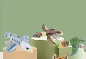 Three colorful bird-shaped plush dog toys with ropes on green cylindrical display stands