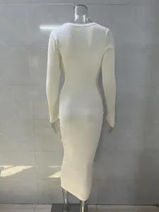 Back view of an elegant long-sleeved ribbed knit maxi dress in a cream white finish