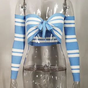 Detail view of blue and white striped knit crop top with bow and matching sleeves