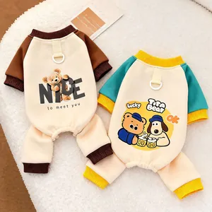 Close-up of pet autumn four-legged jumpsuits with cute cartoon prints and leash D-ring detail.