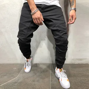 Vista detallada del pantalón cargo negro para hombre con diseño plisado en las rodillas