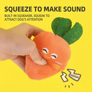 Squeezing a plush carrot toy for dogs to demonstrate the built-in squeaker sound.