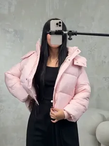 Stylish pink short hooded puffer jacket for women featuring a quilted design for winter warmth