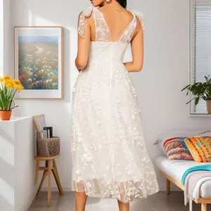 Back view detail of white floral lace V-neck camisole dress with elegant embroidery