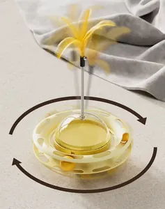Jouet interactif pour chat avec distributeur de croquettes et plume jaune souple.