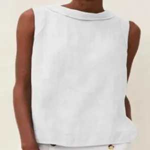 Detail view of a white linen sleeveless casual top featuring an elegant round neckline