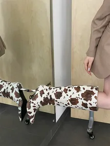 Stilvolle kniehohe Stiefel mit braun-weißem Kuhmuster, spitze Kappe und hohem Stilettoabsatz