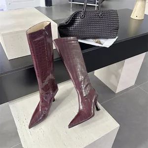 Detailansicht weinroter Kniehoher Stiefel mit Krokodilprägung und elegantem Stöckelabsatz
