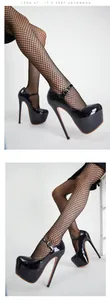 Close-up of 17cm black patent leather platform high heels with ankle strap